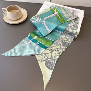Detail of silk skinny scarf featuring vintage equestrian chain patterns in mint green