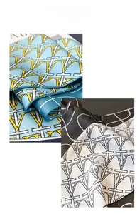 Close-up of sleek geometric V-pattern silk scarves in blue-yellow and black-white