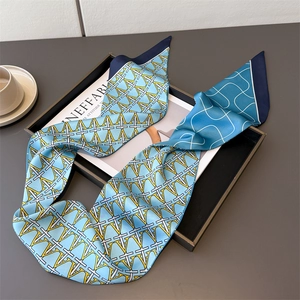 Blue silk neck scarf with letter patterns on magazine tray for casual styling