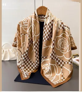 Detail of silk-like houndstooth scarf with rose floral print in earth tones and satin luster