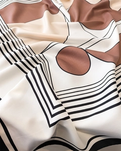 Detail of silk scarf showing geometric round patterns and soft lustrous fabric texture