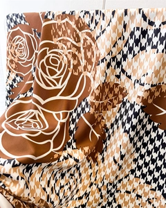 Detail of houndstooth silk scarf with vintage rose floral patterns and silky texture