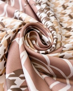 Detailed close-up of brown houndstooth silk scarf showing premium twill texture and sheen