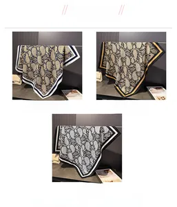 Detailed close-up of paisley silk scarves in navy, black gold and grey silk satin fabric