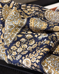 Macro shot of paisley pattern and twill texture on a vintage silk-like square scarf
