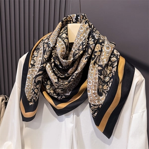 Close-up of paisley pattern on a silky square scarf showing detailed floral textures