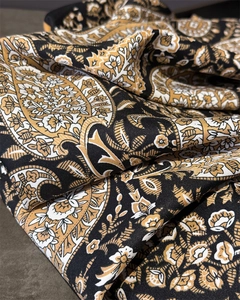 Close-up of the vintage paisley print fabric showing detailed twill texture and golden tones