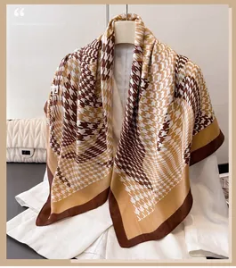 Detailed view of houndstooth silk-like scarf with earth tone color blocking design