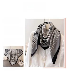 Detailed pattern of houndstooth silk square scarf in classic black, white and grey colors