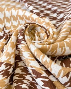 Macro shot of houndstooth silk scarf showing twill texture and autumn color tones