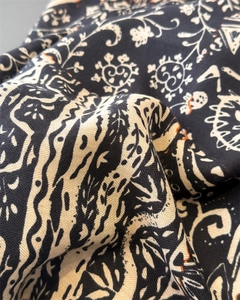 Close-up of retro paisley silk-like scarf showing intricate floral twill fabric detail