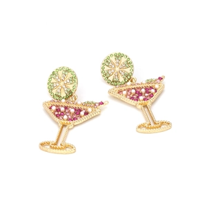 Detail of cocktail glass earrings with pink crystals and green lemon slice studs