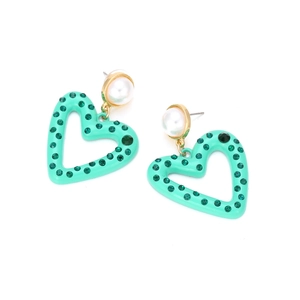 Close-up of mint green heart earrings with sparkling crystals and a white pearl stud