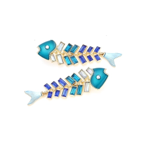Exaggerated fishbone earrings with blue gradient crystals and golden metal frame