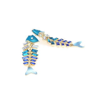 Exaggerated fishbone drop earrings with blue gradient crystals and enamel in gold tone