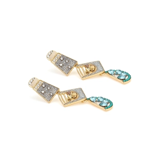 Detail of layered geometric earrings featuring gold plating and multi-colored rhinestones