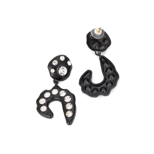Asymmetric black lacquer geometric drop earrings with sparkling rhinestones on white background
