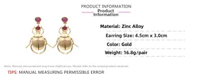 Detail view of gold-plated beetle earrings with pink gemstone inlay and dimensions