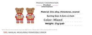 Detail of teddy bear earrings featuring brown rhinestones and red-blue striped sweaters