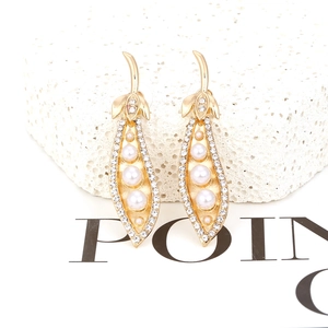 Gold pea pod earrings with white pearls and sparkling crystals on coral stone base