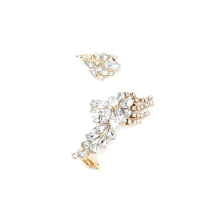 Detail of gold floral tassel earrings with marquise and teardrop crystals on white background