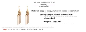 Detail view of gold tassel earrings with size 11cm length and 2cm width specifications