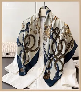 Close-up of elegant silk scarf with equestrian chain print over white shirt