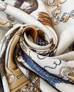 Macro shot of faux silk scarf featuring herringbone texture and equestrian chain print