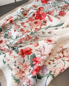 Detail showing floral print silk scarf with fine diagonal twill texture and hemmed edges