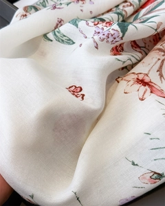 Detail of floral printed fabric with herringbone texture and soft draping effect