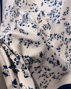 Macro detail of high-quality floral imitation silk scarf with elegant drape and texture