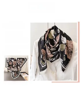 Detail of silk-feel scarf featuring vintage rose prints and black and white striped borders