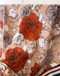 Close-up of romantic rose floral pattern on soft silk scarf with twill weave texture
