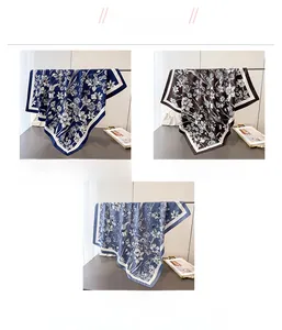 Detailed close-up of floral silk scarves in navy blue, coffee, and foggy blue options