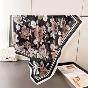 Detailed texture of French rose print silk scarf with classic striped borders