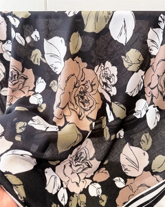 Detailed macro view of large rose floral pattern on soft silk satin fabric scarf