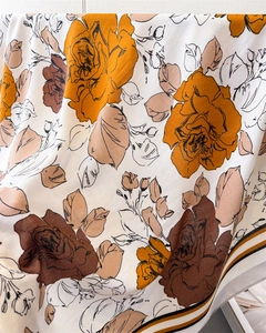 Macro detail of French retro rose print on silk scarf with textured weave and border