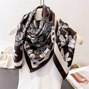 Detailed view of floral faux silk square scarf featuring vintage monochrome prints