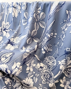 Detailed close-up of blue floral faux silk scarf fabric showing elegant lily print