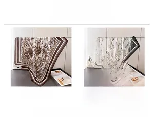 Detail view of coffee and black silk scarves featuring French jungle floral and palm prints