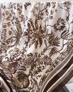 Macro detail of French jungle floral print silk scarf with luxury herringbone texture
