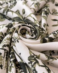 Detailed close-up of green jungle toile de jouy pattern on soft silk satin fabric scarf