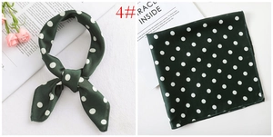 Detail of dark green polka dot silk square scarf showing folded and flat textures