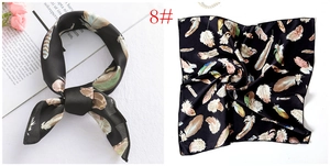 Detail of black silk scarf with colorful feather prints and a soft lustrous texture