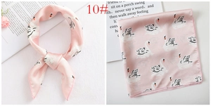 Detailed view of pink silk satin square scarf featuring an elegant swan print pattern