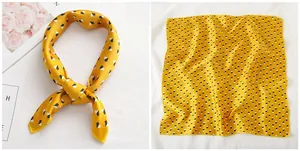 Detail of 50x50cm yellow silk scarf with geometric cube print and smooth satin texture