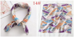 Detail of printed satin square scarf with vintage belt buckle pattern and rolled edges