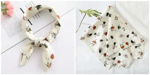 Detail of floral satin square scarf showing delicate hem and elegant silk texture