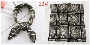 Detail of square satin scarf with vintage nautical compass pattern and silk texture
