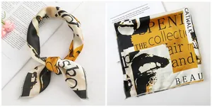 Detail of printed satin silk scarf featuring modern artistic patterns and machine hemmed edges